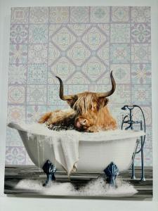 a cow with horns laying in a bath tub at Iron Bound Gem in Newark