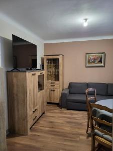 a living room with a couch and a blue sofa at 2 chambres chez l'habitant in Poitiers