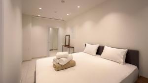 a bedroom with a large white bed with towels on it at City Napa Seaview Villas - Villa 4 in Ayia Napa