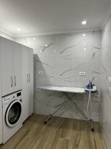 a laundry room with a washer and dryer at Eni entire guesthouse parking on site in Berat