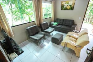 a living room with a couch and two chairs at Sítio Via Láctea - Guaramiranga in Guaramiranga
