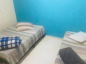 - deux lits assis l'un à côté de l'autre dans une pièce dans l'établissement CASA FAMÍLIA PRÓXIMO À BASÍLICA, à Aparecida