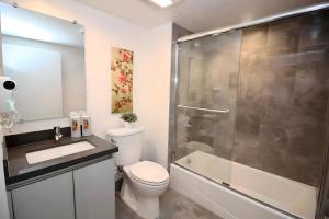 a bathroom with a shower and a toilet and a sink at Los Angeles Premium City Suites with Free Parking in Los Angeles +41 photos