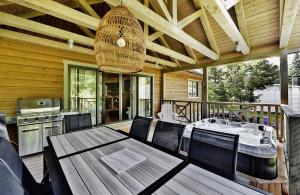 a dining room with a table and chairs on a deck at 25 Chemin Bonair in Stoneham