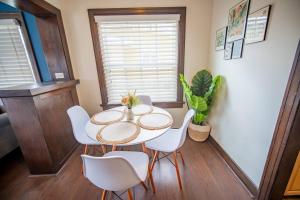 a dining room with a table and white chairs at Sunny Retreat near San Diego Zoo, Beach & Downtown in San Diego