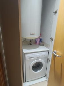 a white washer and dryer in a small bathroom at Apartamento a estrenar en A Pobra do Caramiñal in A Pobra do Caramiñal