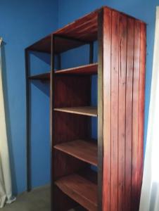 a wooden book shelf in a room at Chill-Inn Nosara in Nosara