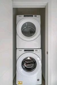 a washing machine and a dryer in a room at Gem Havana 3 bedroom home in Calgary