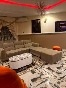a living room with a couch and a table at IMSMART Luxury Homes in Uyo