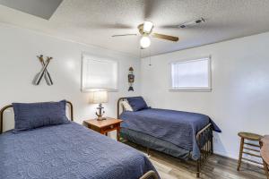 een slaapkamer met 2 bedden en een plafondventilator bij Arkansas Lake House with Private Dock! in Horseshoe Bend