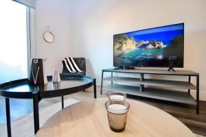 sala de estar con TV de pantalla plana sobre una mesa en Los Angeles Premium 2BR&2BT Suites with Free Parking, en Los Ángeles