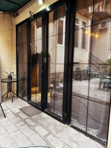 una puerta corredera de cristal abierta en un patio en Hotel Classic Corner en Tiflis