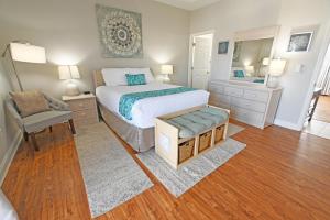 una camera da letto con un letto, una sedia e uno specchio di Sandpiper Cove Unit 4206 a Destin