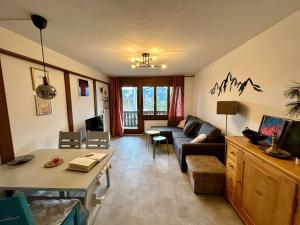 a living room with a couch and a table at Charming Apartment in Laax in Laax