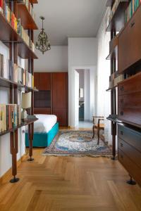 a bedroom with a bed and bookshelves at Dimore Santojanni - Il Salotto dei Portici nel centro di Potenza in Potenza