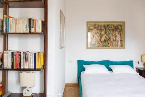 a bedroom with a bed and a book shelf with books at Dimore Santojanni - Il Salotto dei Portici nel centro di Potenza in Potenza