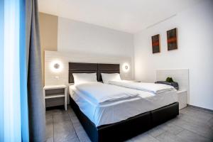 Katil atau katil-katil dalam bilik di Miralago Locarno Easy Rooms