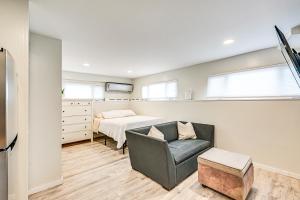a bedroom with a bed and a couch and a chair at Long Island Home 1 Mi to Downtown Garden City in Hempstead