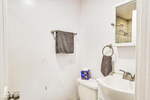 a white bathroom with a sink and a toilet at Long Island Home 1 Mi to Downtown Garden City in Hempstead