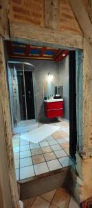 a bathroom with a red sink and a red counter at maison d'hôtes prince face au château du clos Luce in Amboise