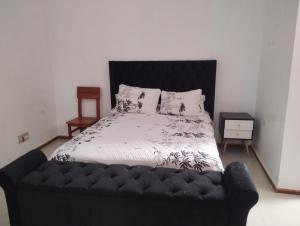 a bedroom with a bed with a black headboard at Casa Maikai Tarapoto in Tarapoto
