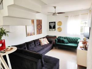 a living room with a couch and a table at Casa da Brisa in Foz do Iguaçu