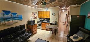 a kitchen with a couch and a table and a refrigerator at Waterfront North Beach Condo with beach and pool access in Corpus Christi