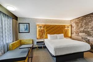 Habitación de hotel con cama y escritorio en LeConte Motor Lodge A Ramada by Wyndham, en Gatlinburg
