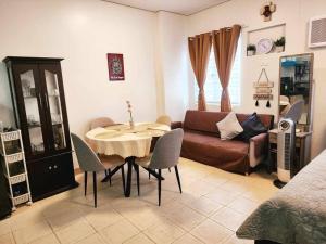 a living room with a table and a couch at Casa De Castillo in Marilao