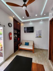 a living room with a ceiling fan and a couch at CASA GALAPAGOS by Hostal Fragata in Puerto Ayora