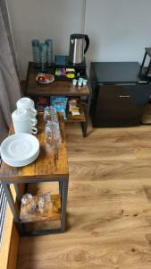 a living room with two tables with dishes on them at Top Floor Room in Baker St in London