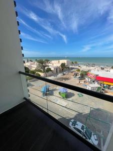 a balcony with a view of a city and the ocean at REGMAR Progreso Yucatán in Progreso