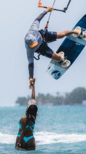 a woman in the water with a man on a wake board at Sea Avenue Hotel in San Andrés