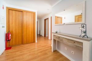 a kitchen with a counter and a wooden door at Lovely&Cozy apartment in Lagoa +28 photos