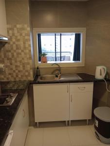 a small kitchen with a sink and a window at luxmar beach in Benidorm