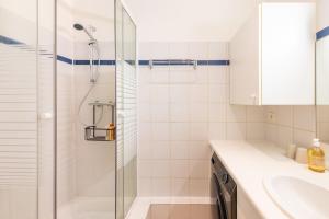 a bathroom with a shower and a sink at Cosy & Well-Connected 1BD ApartmentSaint Lazare in Paris