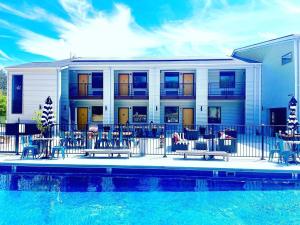 a building with a pool in front of a house at Queen Room For Two Near Purina Farms in Pacific