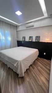 a bedroom with a large bed in a room at Casa Aconchegante in Belo Horizonte