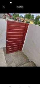 een rode deur aan de zijkant van een gebouw bij Yang guest house/private room in Dauis +4 foto's