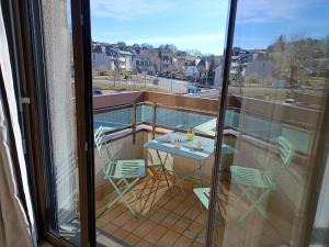 a balcony with a table and chairs on a balcony at Best Western Le Relais de Laguiole Hôtel & Spa in Laguiole