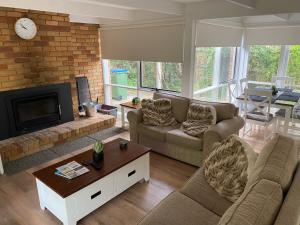 a living room with two couches and a fireplace at Beauna Vista Rye Retreat Home in Rye