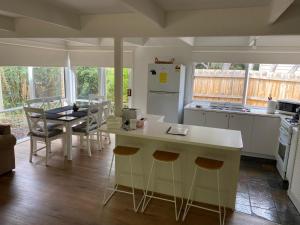 a kitchen with a counter and a table with chairs at Beauna Vista Rye Retreat Home in Rye
