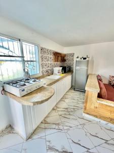 a kitchen with a stove and a refrigerator at Surf house apartment in Oualidia