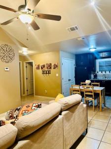a living room with a couch and a dining room at Western Style - 2 bed/1 bath (RATED 10 STARS) in Eagle Pass