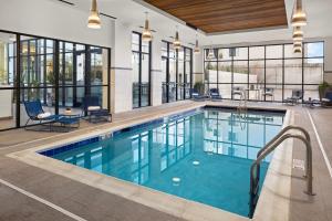 a swimming pool in a hotel with glass windows at Element Bozeman in Bozeman