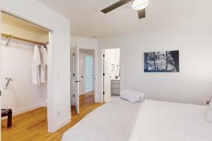 an apartment with white walls and wood floors at Poree Domaine Bend in Bend