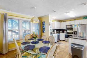 a dining room with a table and chairs and a kitchen at Tressa Terrace in Avon