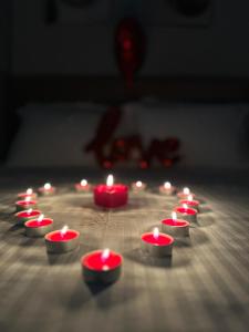 a group of red candles in a circle on a table at Bee Hotel in Vlorë