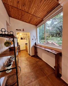 a room with a large window and a tiled floor at Casa Feito Tafi in Tafí del Valle +5 photos