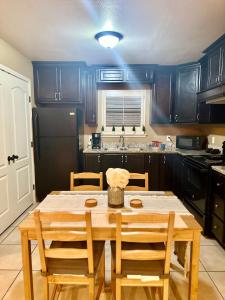 a kitchen with a wooden table with chairs and a sink at Western Style - 2 bed/1 bath (RATED 10 STARS) in Eagle Pass